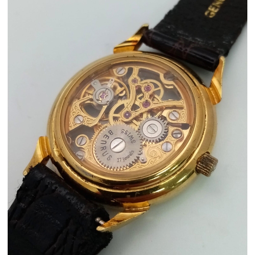 502 - A Benrus Gilded Skeleton Watch. Brown leather strap. Skeleton case - 31mm. In working order.
12018