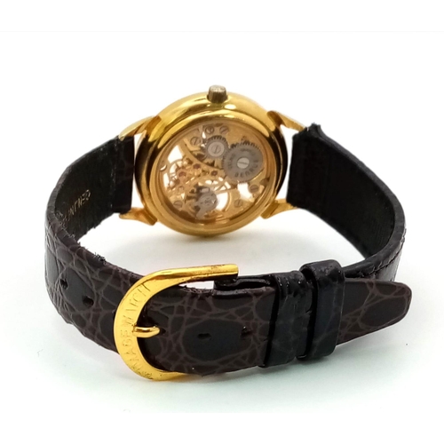 502 - A Benrus Gilded Skeleton Watch. Brown leather strap. Skeleton case - 31mm. In working order.
12018