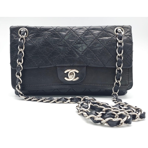 57 - A Chanel Black Crossbody Bag. Quilted leather exterior, with the iconic CC logo on the front flap. T... 