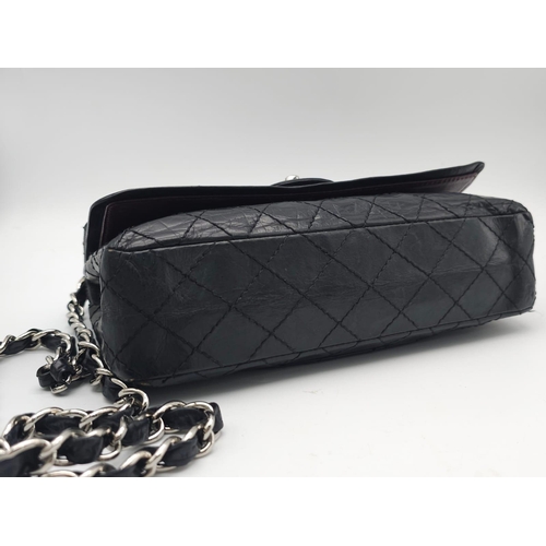 57 - A Chanel Black Crossbody Bag. Quilted leather exterior, with the iconic CC logo on the front flap. T... 