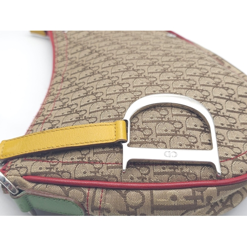 578 - A Christian Dior Rasta Saddle Shoulder Bag. Tan and brown monogram canvas with red piping exterior. ... 