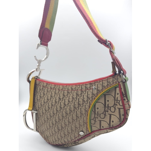 578 - A Christian Dior Rasta Saddle Shoulder Bag. Tan and brown monogram canvas with red piping exterior. ... 