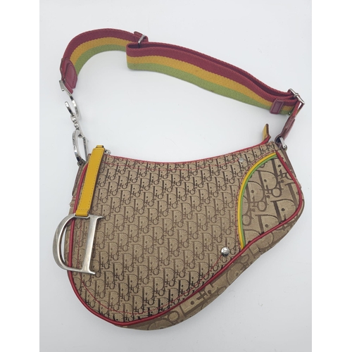 578 - A Christian Dior Rasta Saddle Shoulder Bag. Tan and brown monogram canvas with red piping exterior. ... 