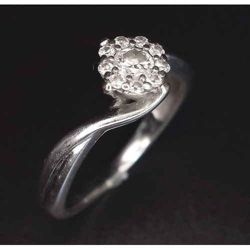 607 - A 9 K white gold ring with a diamond cluster (0.25 carats) in a twist design. Size: L, weight: 2.3 g... 