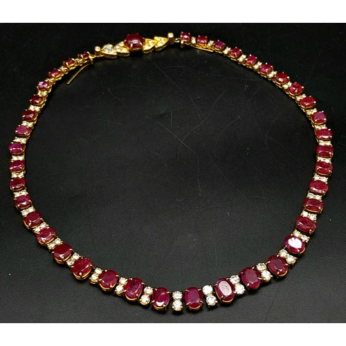 53 - A vintage, 9 K yellow gold necklace loaded with oval cut natural rubies and round cut diamonds. Leng... 