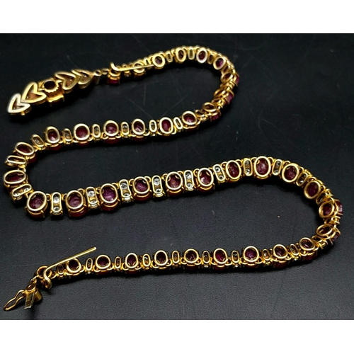 53 - A vintage, 9 K yellow gold necklace loaded with oval cut natural rubies and round cut diamonds. Leng... 