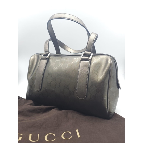 641 - A Gucci Metallic Grey Boston Bag. Patent monogram leather exterior.  Brown textile interior with inn... 