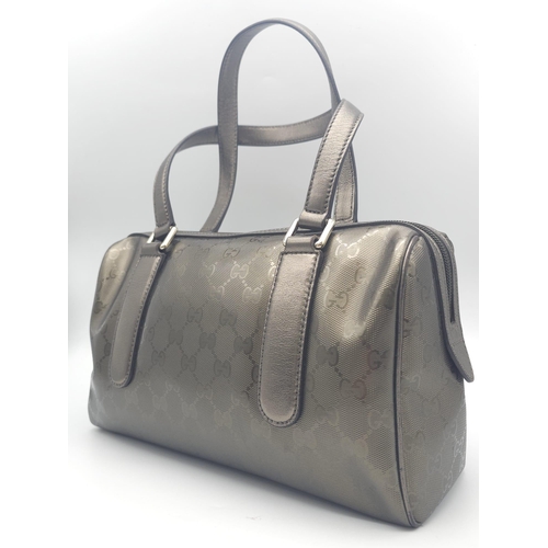 641 - A Gucci Metallic Grey Boston Bag. Patent monogram leather exterior.  Brown textile interior with inn... 