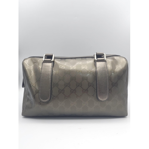 641 - A Gucci Metallic Grey Boston Bag. Patent monogram leather exterior.  Brown textile interior with inn... 