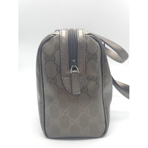 641 - A Gucci Metallic Grey Boston Bag. Patent monogram leather exterior.  Brown textile interior with inn... 