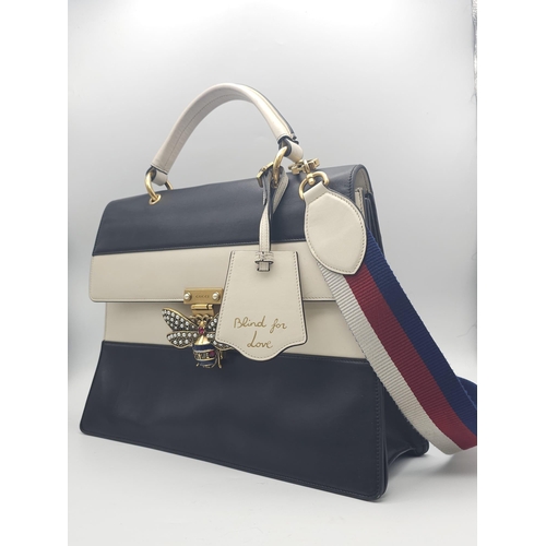 669 - A GUCCI Large QUEEN MARGARET TOP HANDLE BAG in Black with a beige strip across the front. The bag ha... 