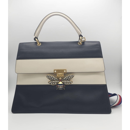 669 - A GUCCI Large QUEEN MARGARET TOP HANDLE BAG in Black with a beige strip across the front. The bag ha... 