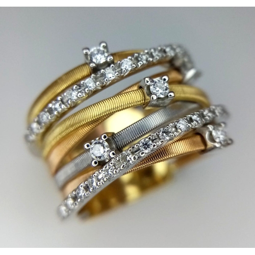 50 - An Italian 18K Yellow and White Gold Diamond Orbital Ring. Front band of gold interspersed with bril... 