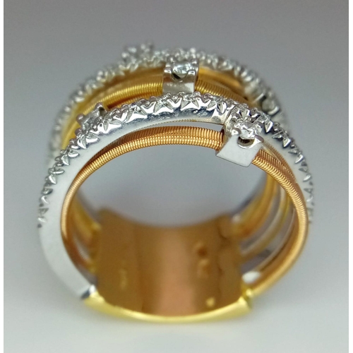 50 - An Italian 18K Yellow and White Gold Diamond Orbital Ring. Front band of gold interspersed with bril... 