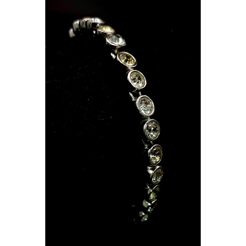 821 - An Ex Display Swarovski Crystal Set Tennis Bracelet. 17cm Length. Set with 4mm Round Cut Pale Yellow... 