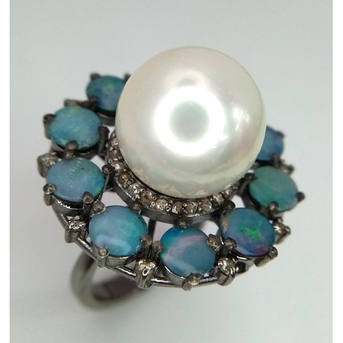 839 - A Sterling Silver, Pearl and Opal Ring. A 20ct central pearl with a halo of 4.7ct of opals. Size O/P... 