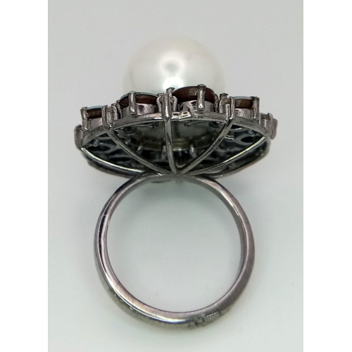 839 - A Sterling Silver, Pearl and Opal Ring. A 20ct central pearl with a halo of 4.7ct of opals. Size O/P... 