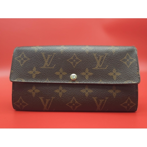 878 - Louis Vuitton Wallet.
Measuring 18.5cm wide, this Louis Vuitton wallet is patterned in the trademark... 