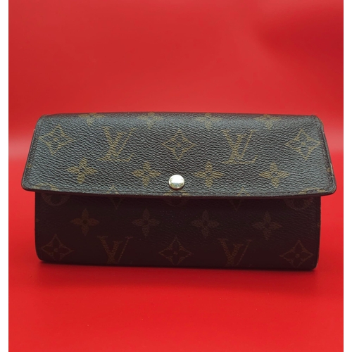 878 - Louis Vuitton Wallet.
Measuring 18.5cm wide, this Louis Vuitton wallet is patterned in the trademark... 