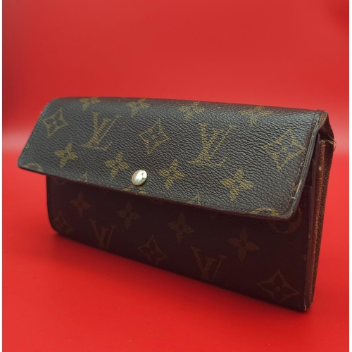 878 - Louis Vuitton Wallet.
Measuring 18.5cm wide, this Louis Vuitton wallet is patterned in the trademark... 