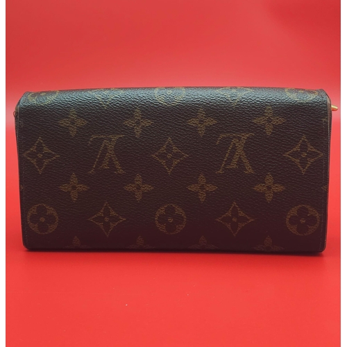 878 - Louis Vuitton Wallet.
Measuring 18.5cm wide, this Louis Vuitton wallet is patterned in the trademark... 