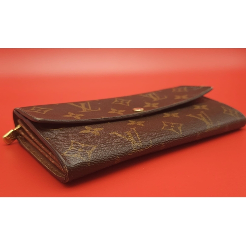 878 - Louis Vuitton Wallet.
Measuring 18.5cm wide, this Louis Vuitton wallet is patterned in the trademark... 