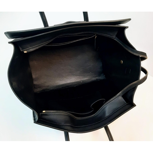 116 - Celine Black Luggage Handbag.
Quality leather interior/exterior. Design offers ample space for all y... 