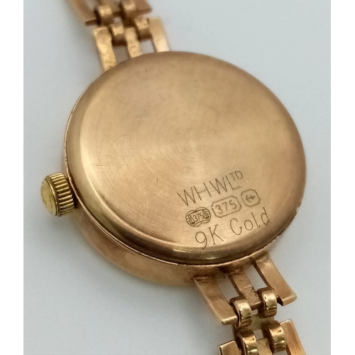 812 - A W.H.WILMOTT OF BIRMINGHAM LADIES 9K GOLD WATCH WITH SOLID GOLD STRAP , WHITE DIAL AND SWISS MOVEME... 