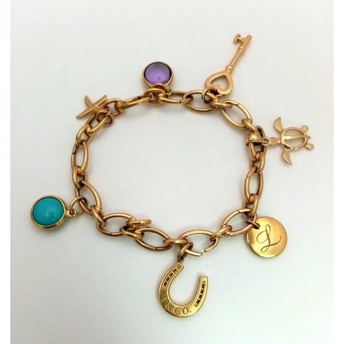 39 - An 18 K yellow gold TIFFANY chain bracelet with seven charms. Length: 18.5 cm, weight: 30.4 g. In a ... 