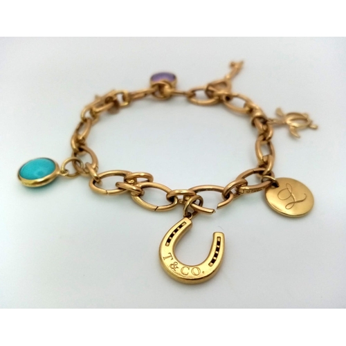 39 - An 18 K yellow gold TIFFANY chain bracelet with seven charms. Length: 18.5 cm, weight: 30.4 g. In a ... 