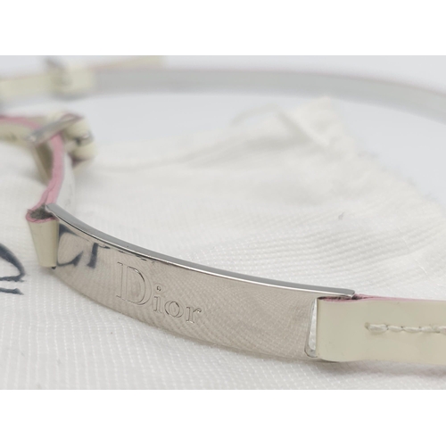 857 - Christian Dior White Leather & Chain Belt.
This stylish CD belt features pink highlights on white le... 