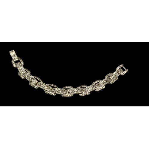 218 - A vintage, sterling silver bracelet, with an elaborate filigree design studded with marcasite. With ... 