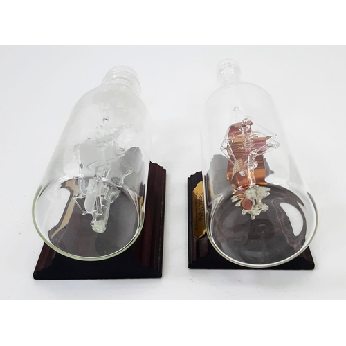 975 - A Pair of Vintage Glass Ships in Bottles of the Bounty & the Santa Maria on Wooden Plinths 23 & 19cm... 