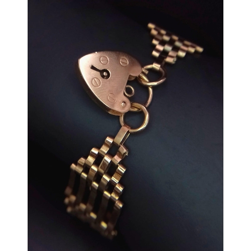10 - A VINTAGE 9K ROSE GOLD GATE BRACELET WITH INDIVIDUAL HALLMARKS ON EVERY GATE AND HEART SHAPED PADLOC... 