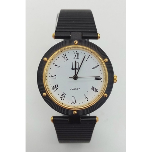 361 - A Dunhill Quartz Mid-Size Watch. Black metal strap and case - 32mm. White dial with roman numerals. ... 