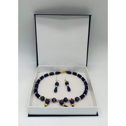 204 - A regal, lapis lazuli and gilded spacers necklace and earrings set in a presentation box. Necklace l... 