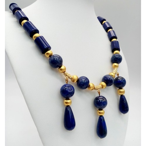 204 - A regal, lapis lazuli and gilded spacers necklace and earrings set in a presentation box. Necklace l... 