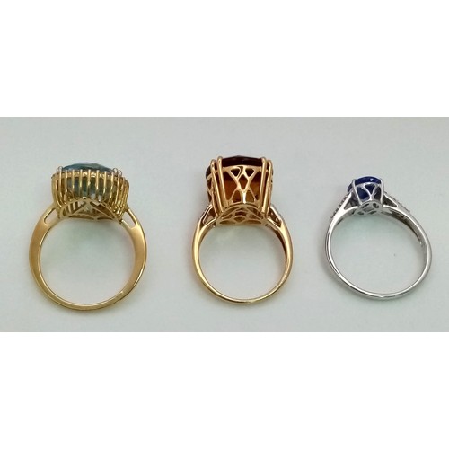 179 - Three 18 K gold rings, one with an oval cut tanzanite and diamonds on the shoulders, size: S, one wi... 