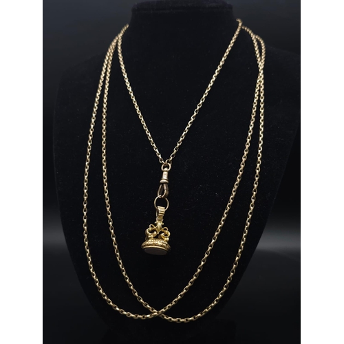 33 - An Antique 9K Yellow Gold Long Pocket Watch Chain with a Hanging 9K Yellow Gold Fob with Chalcedony ... 