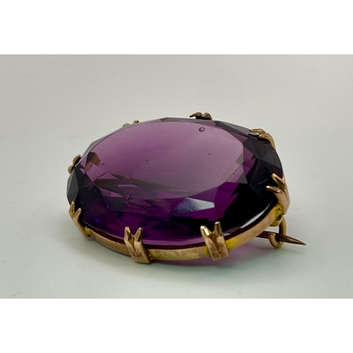 45 - An Antique Amethyst Brooch set in 9K Rose Gold. A large oval well-faceted clean amethyst in a claw s... 