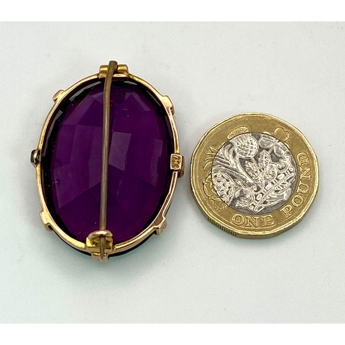 45 - An Antique Amethyst Brooch set in 9K Rose Gold. A large oval well-faceted clean amethyst in a claw s... 