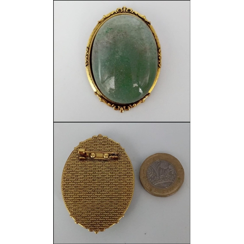 590 - A Green Jade Bead Necklace and Brooch. 14mm beads. 44cm necklace length with a gilded clasp. 5cm ova... 
