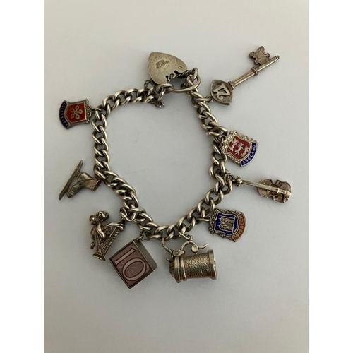 28 - Vintage SILVER CHARM BRACELET Complete with safety chain. Charms to include Tankard, 10 shilling not... 