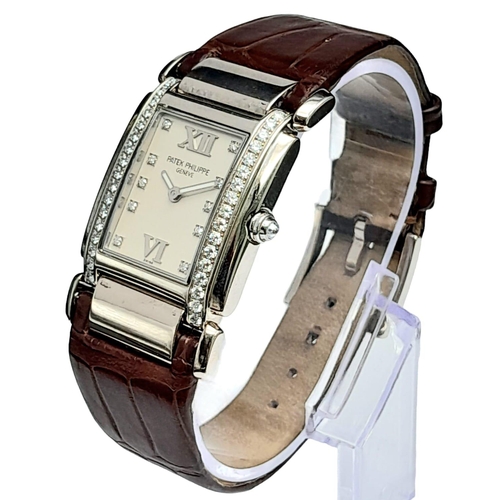 43 - A Vintage Patek Philippe 18K White Gold and Diamond Ladies Watch. Brown leather strap with 18k gold ... 