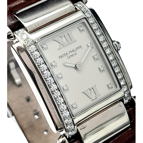 43 - A Vintage Patek Philippe 18K White Gold and Diamond Ladies Watch. Brown leather strap with 18k gold ... 