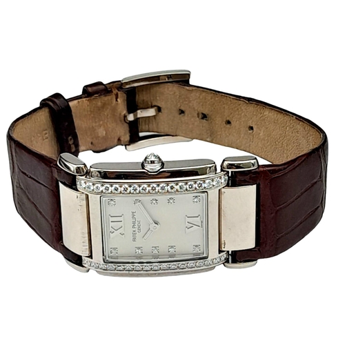 43 - A Vintage Patek Philippe 18K White Gold and Diamond Ladies Watch. Brown leather strap with 18k gold ... 