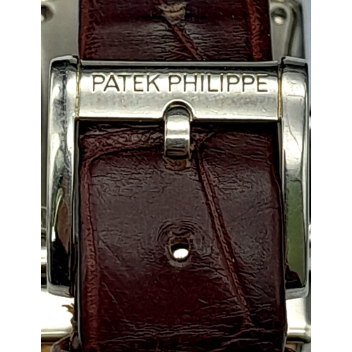 43 - A Vintage Patek Philippe 18K White Gold and Diamond Ladies Watch. Brown leather strap with 18k gold ... 