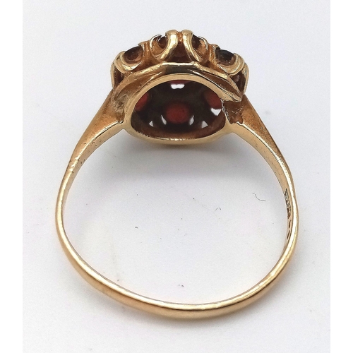 556 - A 9K YELLOW GOLD GARNET CLUSTER RING. Size P, 3g total weight.