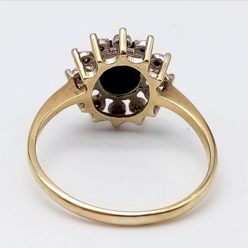 601 - A 9K YELLOW GOLD DIAMOND & SAPPHIRE CLUSTER RING. Size R, 2.5g total weight.
