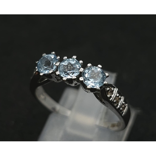 549 - A 9K WHITE GOLD DIAMOND & BLUE TOPAZ RING 3.1G SIZE O